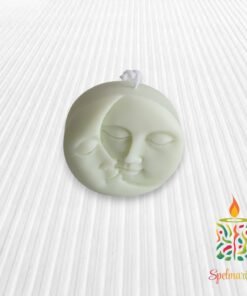 Vela con silueta de sol y luna verde